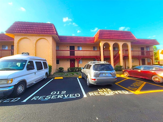 2864 N Powers Dr Unit 150, Orlando, FL 32818 - view of building exterior featuring uncovered parking