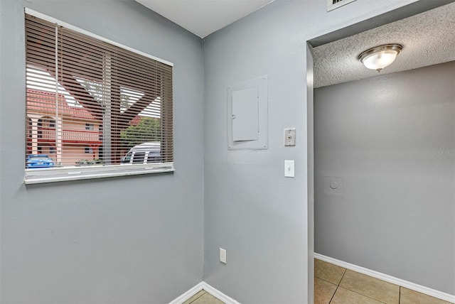 2864 N Powers Dr Unit 150, Orlando, FL 32818 - clothes washing area with baseboards and light tile patterned floors