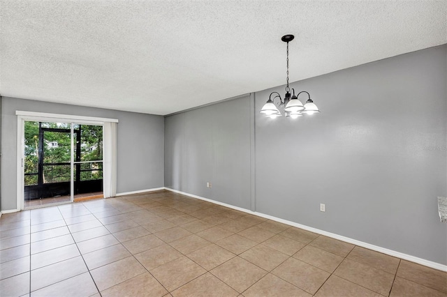 2864 N Powers Dr Unit 150, Orlando, FL 32818 - spare room with a chandelier, a textured ceiling, light tile patterned floors, and baseboards