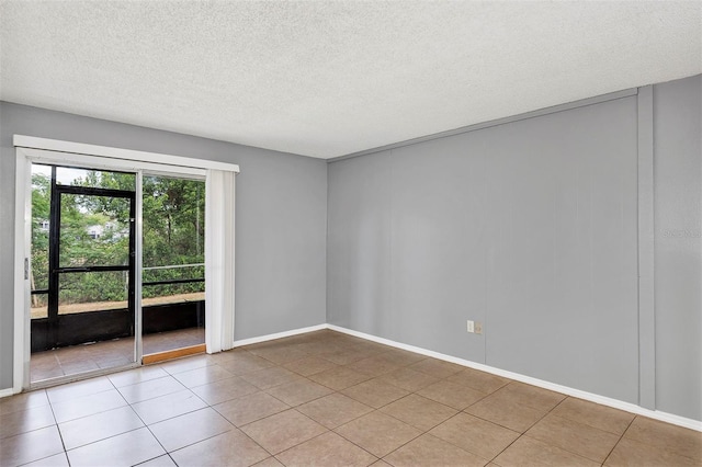 2864 N Powers Dr Unit 150, Orlando, FL 32818 - unfurnished room with a textured ceiling, light tile patterned floors, and baseboards