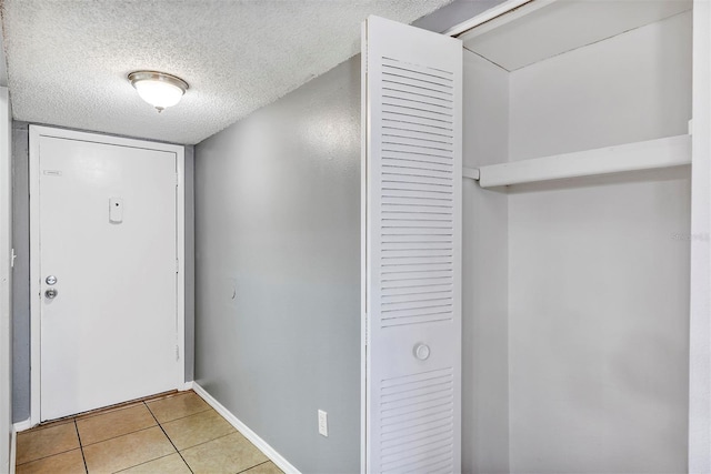 2864 N Powers Dr Unit 150, Orlando, FL 32818 - entryway featuring a textured ceiling and light tile patterned floors