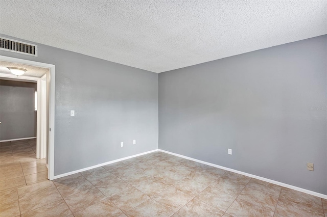 2864 N Powers Dr Unit 150, Orlando, FL 32818 - tiled spare room featuring baseboards and a textured ceiling