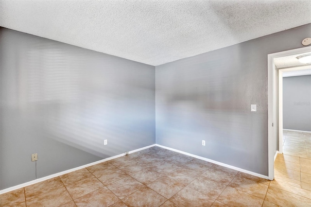 2864 N Powers Dr Unit 150, Orlando, FL 32818 - empty room with tile patterned flooring, a textured ceiling, baseboards, and a smoke detector