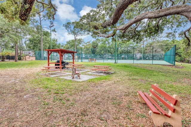 2864 N Powers Dr Unit 150, Orlando, FL 32818 - view of yard with a tennis court