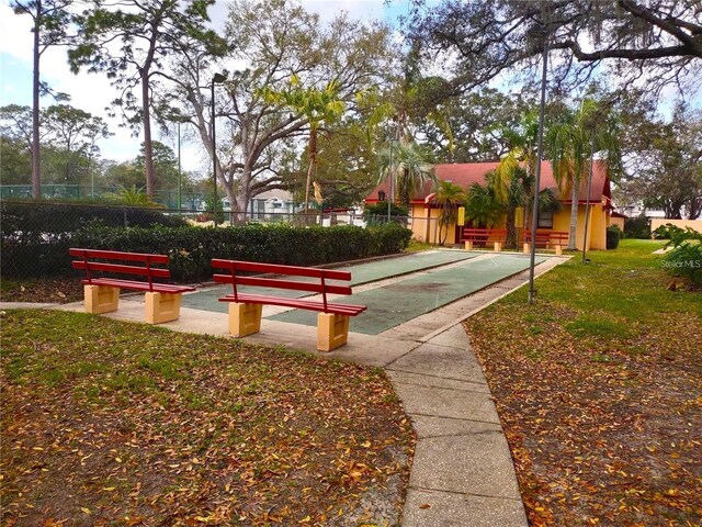 2864 N Powers Dr Unit 150, Orlando, FL 32818 - view of community with shuffleboard and fence