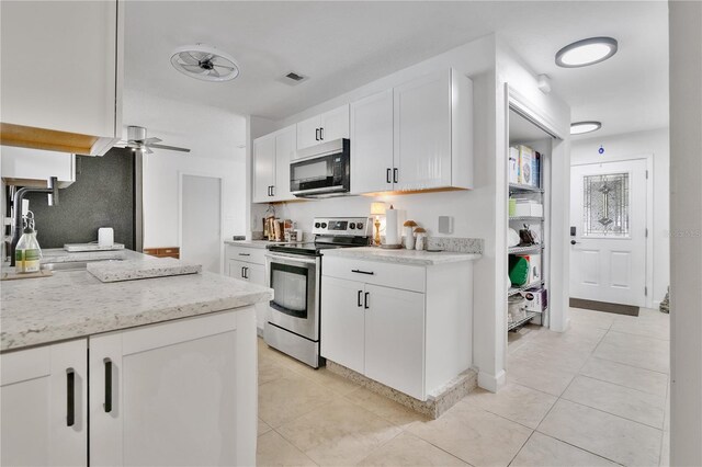5234 Ohio St, Winter Park, FL 32792 - kitchen featuring appliances with stainless steel finishes, a sink, a ceiling fan, and white cabinetry