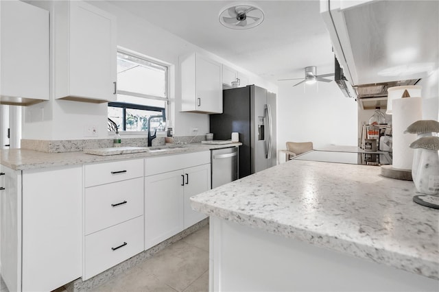 5234 Ohio St, Winter Park, FL 32792 - kitchen with appliances with stainless steel finishes, a ceiling fan, white cabinetry, light tile patterned flooring, and a sink