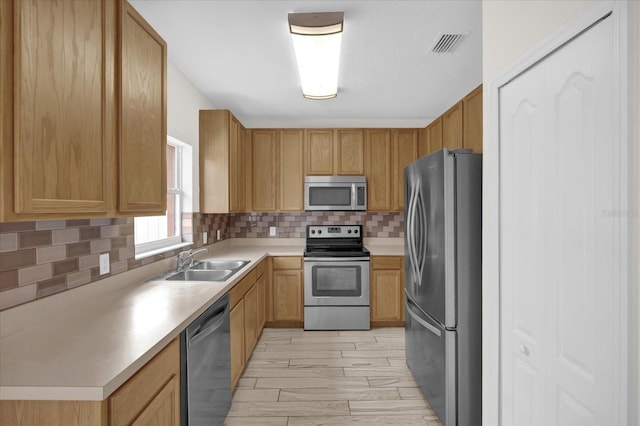 13758 Daniels Landing Cir, Winter Garden, FL 34787 - kitchen with appliances with stainless steel finishes, a sink, backsplash, and light countertops