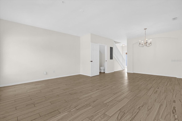 13758 Daniels Landing Cir, Winter Garden, FL 34787 - unfurnished living room with a chandelier, wood finished floors, electric panel, and baseboards