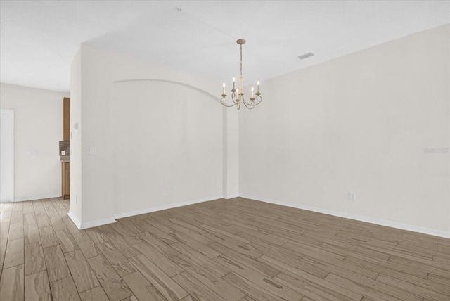 13758 Daniels Landing Cir, Winter Garden, FL 34787 - unfurnished room featuring wood finished floors, a chandelier, and baseboards