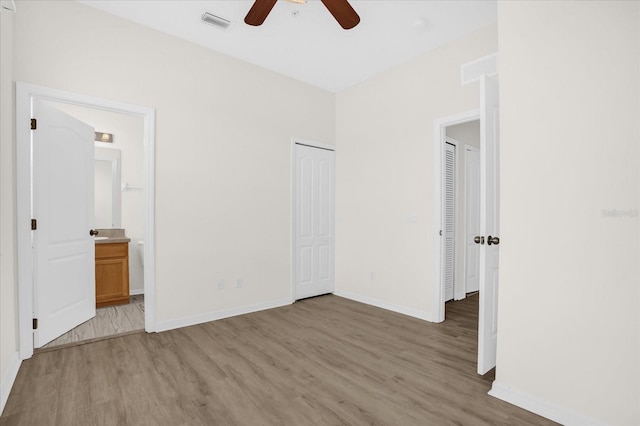 13758 Daniels Landing Cir, Winter Garden, FL 34787 - unfurnished bedroom with light wood finished floors, baseboards, a closet, ensuite bath, and ceiling fan
