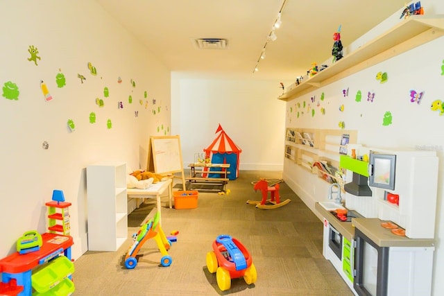 5245 W Irlo Bronson Memorial Hwy Unit 148, Kissimmee, FL 34746 - rec room with rail lighting, carpet, and baseboards