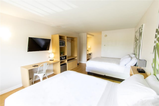 5245 W Irlo Bronson Memorial Hwy Unit 148, Kissimmee, FL 34746 - bedroom with light wood-type flooring and baseboards