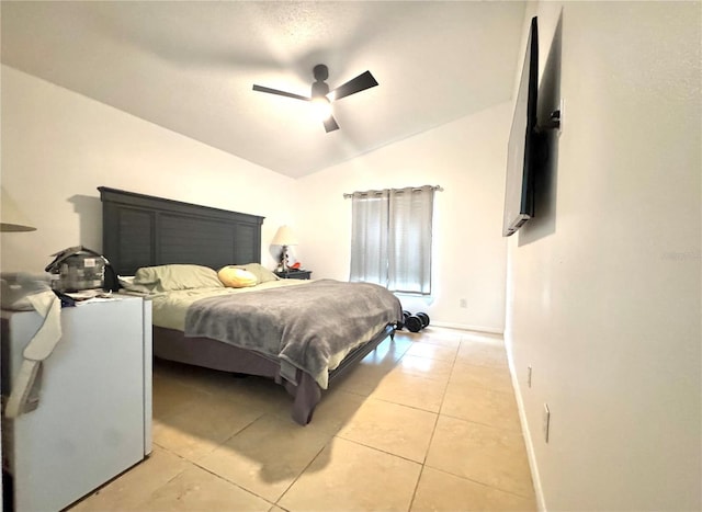bedroom with light tile patterned floors, lofted ceiling, baseboards, and ceiling fan