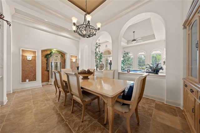 1654 Marina Lake Dr, Kissimmee, FL 34744 - dining area with a tray ceiling, ornamental molding, stone tile floors, a chandelier, and baseboards