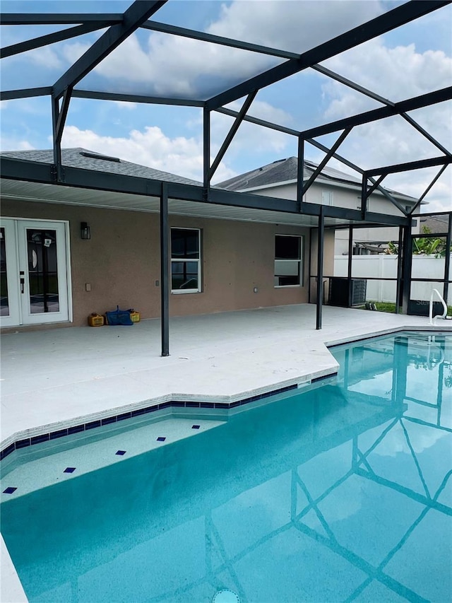 swimming pool with a patio area and a lanai