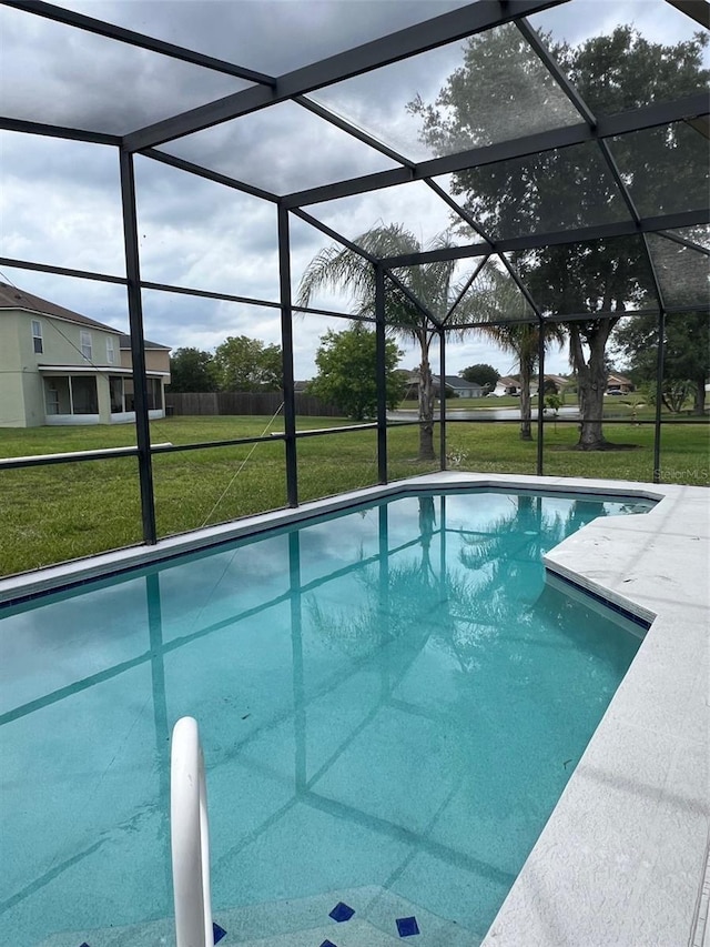 outdoor pool featuring a yard and a lanai