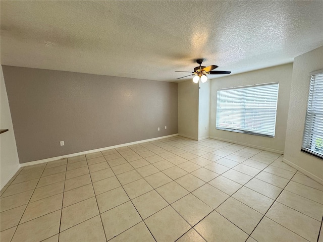 2330 Prime Cir Unit A, Kissimmee, FL 34746 - empty room with ceiling fan, a textured ceiling, light tile patterned floors, and baseboards