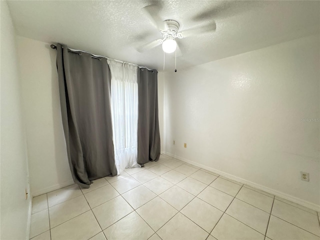 2330 Prime Cir Unit A, Kissimmee, FL 34746 - unfurnished room with a textured ceiling, a ceiling fan, light tile patterned flooring, and baseboards