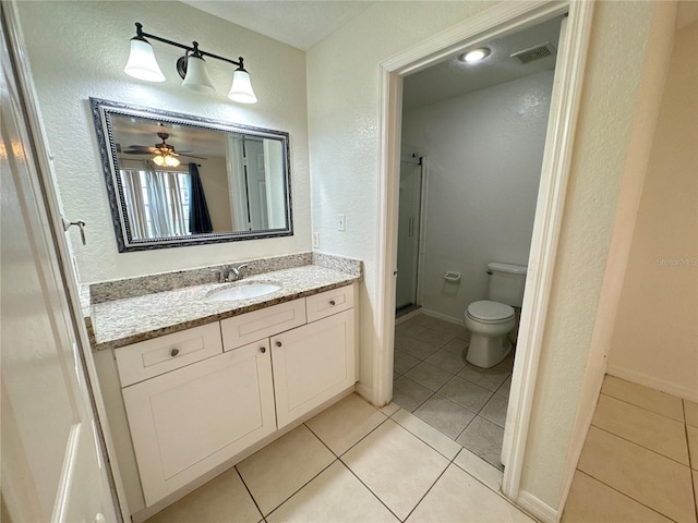 2330 Prime Cir Unit A, Kissimmee, FL 34746 - bathroom with a stall shower, tile patterned floors, a textured wall, vanity, and toilet