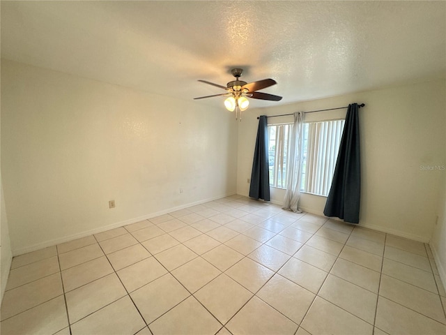 2330 Prime Cir Unit A, Kissimmee, FL 34746 - spare room featuring a ceiling fan, light tile patterned floors, a textured ceiling, and baseboards
