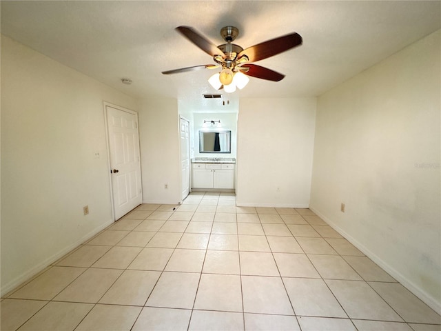 2330 Prime Cir Unit A, Kissimmee, FL 34746 - spare room with ceiling fan, light tile patterned flooring, and baseboards