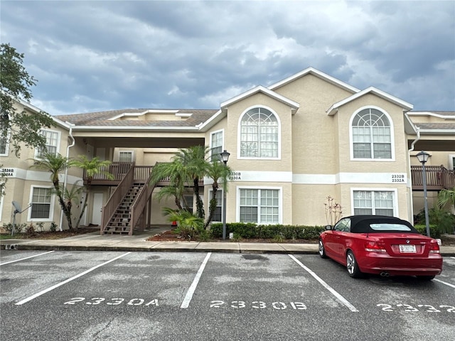 2330 Prime Cir Unit A, Kissimmee, FL 34746 - view of property with uncovered parking and stairway
