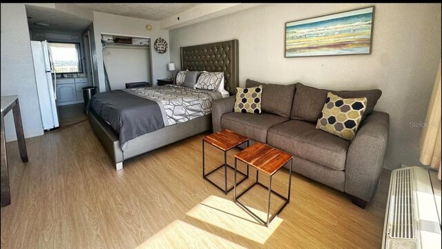 2700 N Atlantic Ave Unit 429, Daytona Beach, FL 32118 - bedroom with light wood-type flooring and freestanding refrigerator