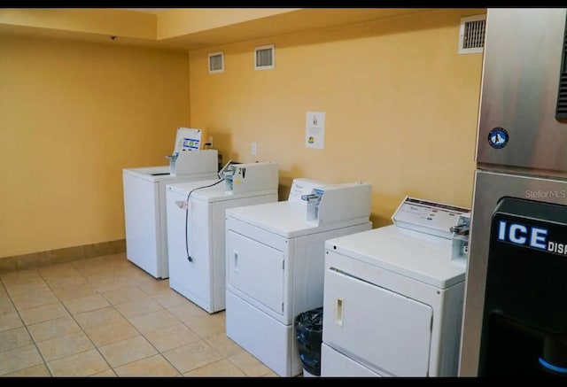 2700 N Atlantic Ave Unit 429, Daytona Beach, FL 32118 - communal laundry room with washing machine and dryer, light tile patterned flooring, and baseboards