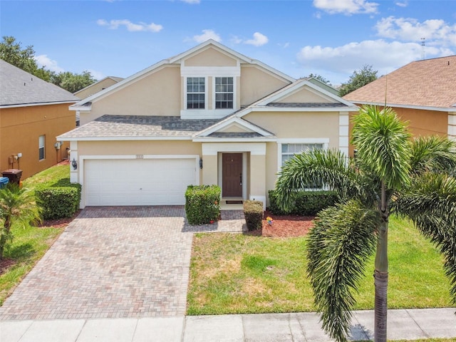 223 Cadiz Loop, Davenport, FL 33837 - traditional-style home with stucco siding, decorative driveway, a shingled roof, and a front lawn
