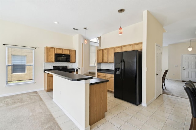 223 Cadiz Loop, Davenport, FL 33837 - kitchen featuring black appliances, dark countertops, backsplash, and hanging light fixtures
