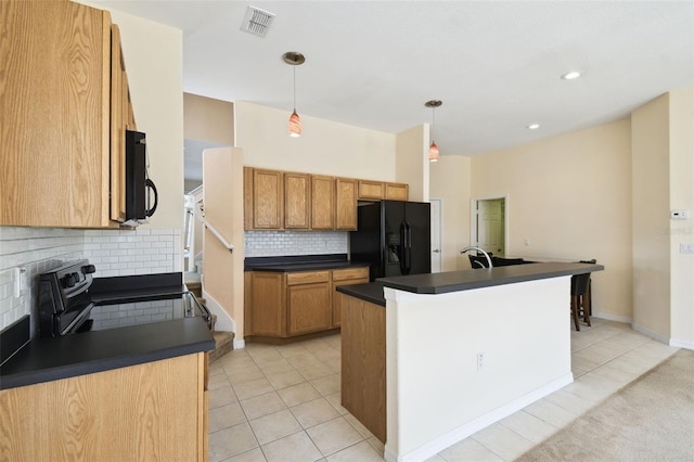 223 Cadiz Loop, Davenport, FL 33837 - kitchen featuring black appliances, dark countertops, decorative backsplash, light tile patterned flooring, and decorative light fixtures