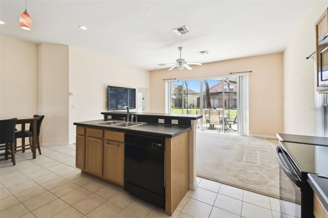 223 Cadiz Loop, Davenport, FL 33837 - kitchen featuring black appliances, dark countertops, a sink, light tile patterned floors, and a center island with sink