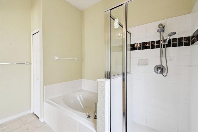 223 Cadiz Loop, Davenport, FL 33837 - bathroom featuring a stall shower, a bath, and tile patterned flooring