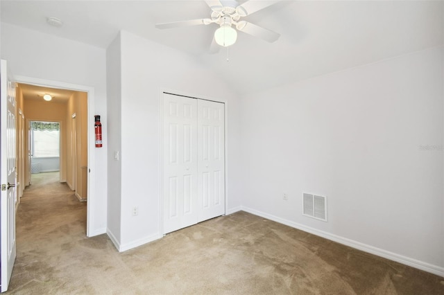 223 Cadiz Loop, Davenport, FL 33837 - unfurnished bedroom featuring light carpet, baseboards, a closet, and lofted ceiling