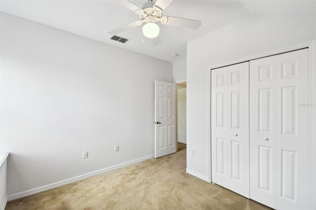 223 Cadiz Loop, Davenport, FL 33837 - unfurnished bedroom featuring light colored carpet, baseboards, a closet, and a ceiling fan