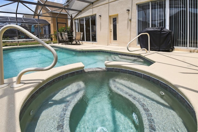 223 Cadiz Loop, Davenport, FL 33837 - view of pool featuring a patio area, a pool with connected hot tub, and glass enclosure