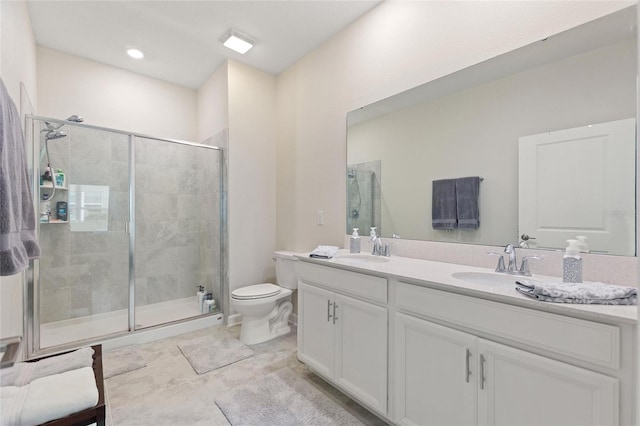 full bath featuring a stall shower, toilet, and double vanity