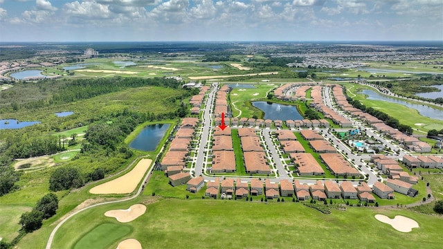aerial overview of property's location with a local golf course, a nearby body of water, and nearby suburban area
