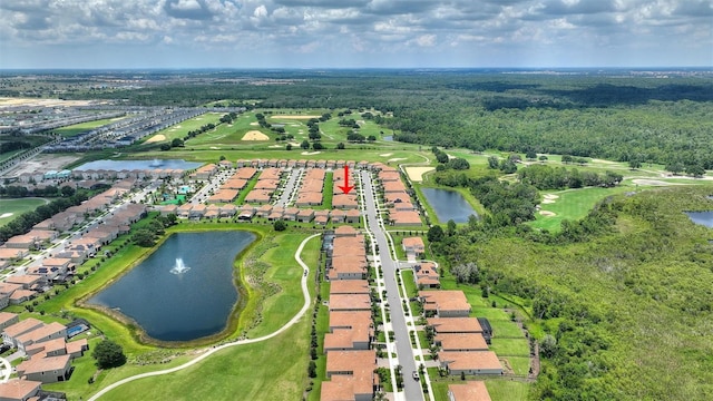 aerial view of property's location featuring a large body of water, nearby suburban area, and a golf course