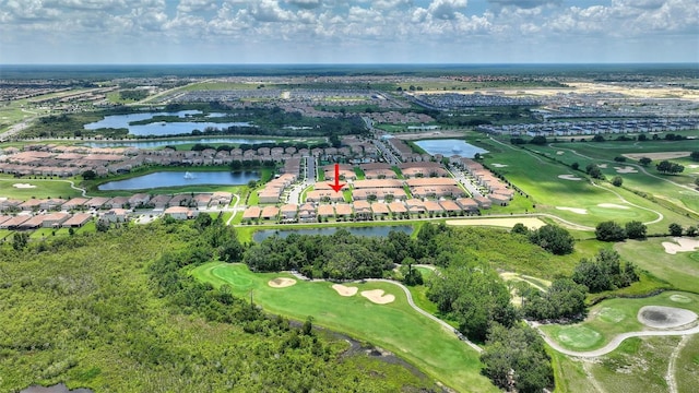 aerial view of property's location with a large body of water, a golf club, and nearby suburban area