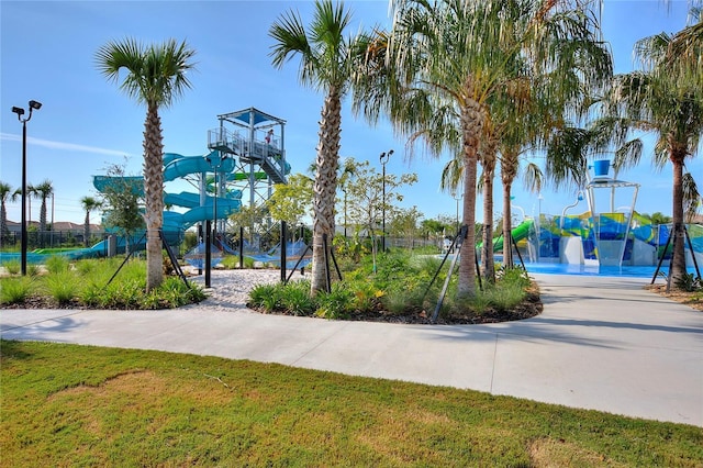 view of basketball court with a yard