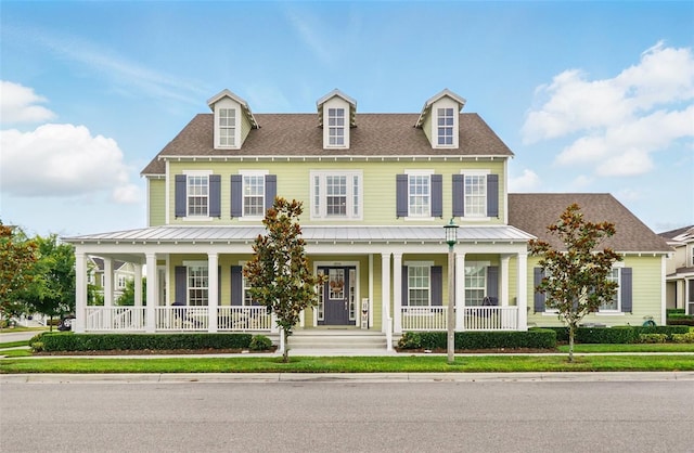 1850 Treasure Cv, Celebration, FL 34747 - view of front of house with a porch, a standing seam roof, and metal roof
