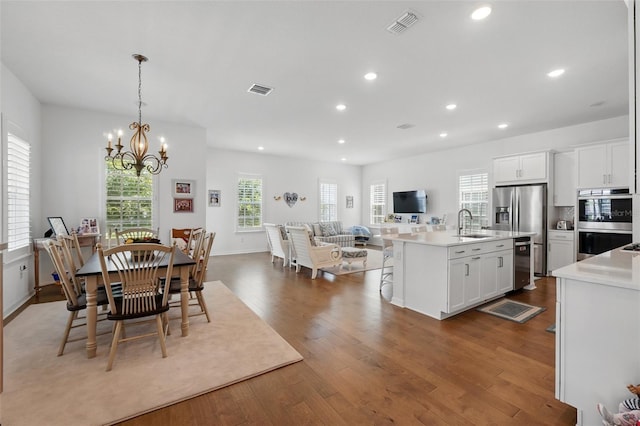 1850 Treasure Cv, Celebration, FL 34747 - dining area featuring dark wood-style flooring, a chandelier, recessed lighting, and baseboards