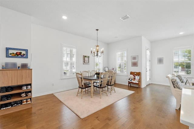 1850 Treasure Cv, Celebration, FL 34747 - dining room featuring wood finished floors, healthy amount of natural light, a chandelier, baseboards, and recessed lighting