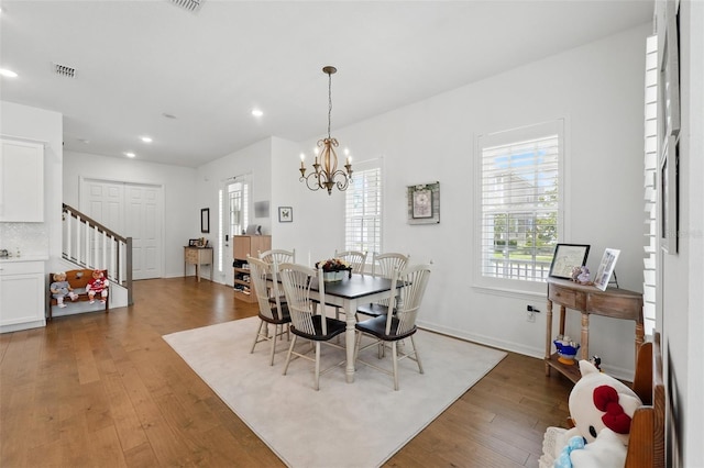 1850 Treasure Cv, Celebration, FL 34747 - dining space with stairs, wood finished floors, recessed lighting, a chandelier, and baseboards
