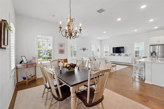 1850 Treasure Cv, Celebration, FL 34747 - dining space with wood finished floors, recessed lighting, and a chandelier