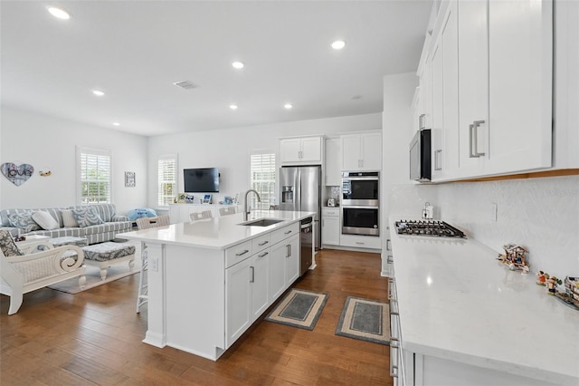 1850 Treasure Cv, Celebration, FL 34747 - kitchen with open floor plan, a sink, stainless steel appliances, white cabinets, and recessed lighting
