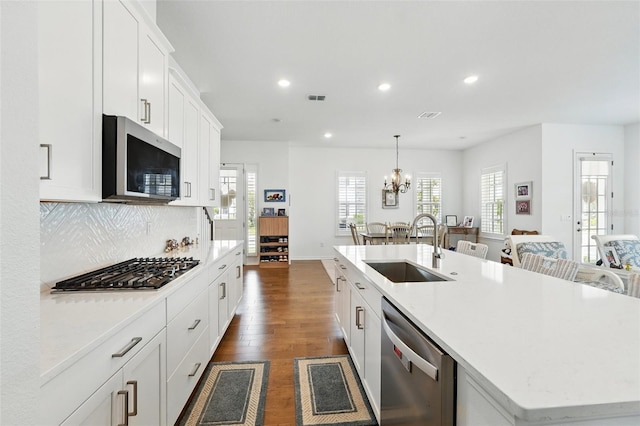 1850 Treasure Cv, Celebration, FL 34747 - kitchen featuring appliances with stainless steel finishes, a sink, recessed lighting, an island with sink, and dark wood finished floors