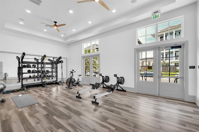 1850 Treasure Cv, Celebration, FL 34747 - exercise area featuring a ceiling fan, a high ceiling, wood finished floors, recessed lighting, and a raised ceiling